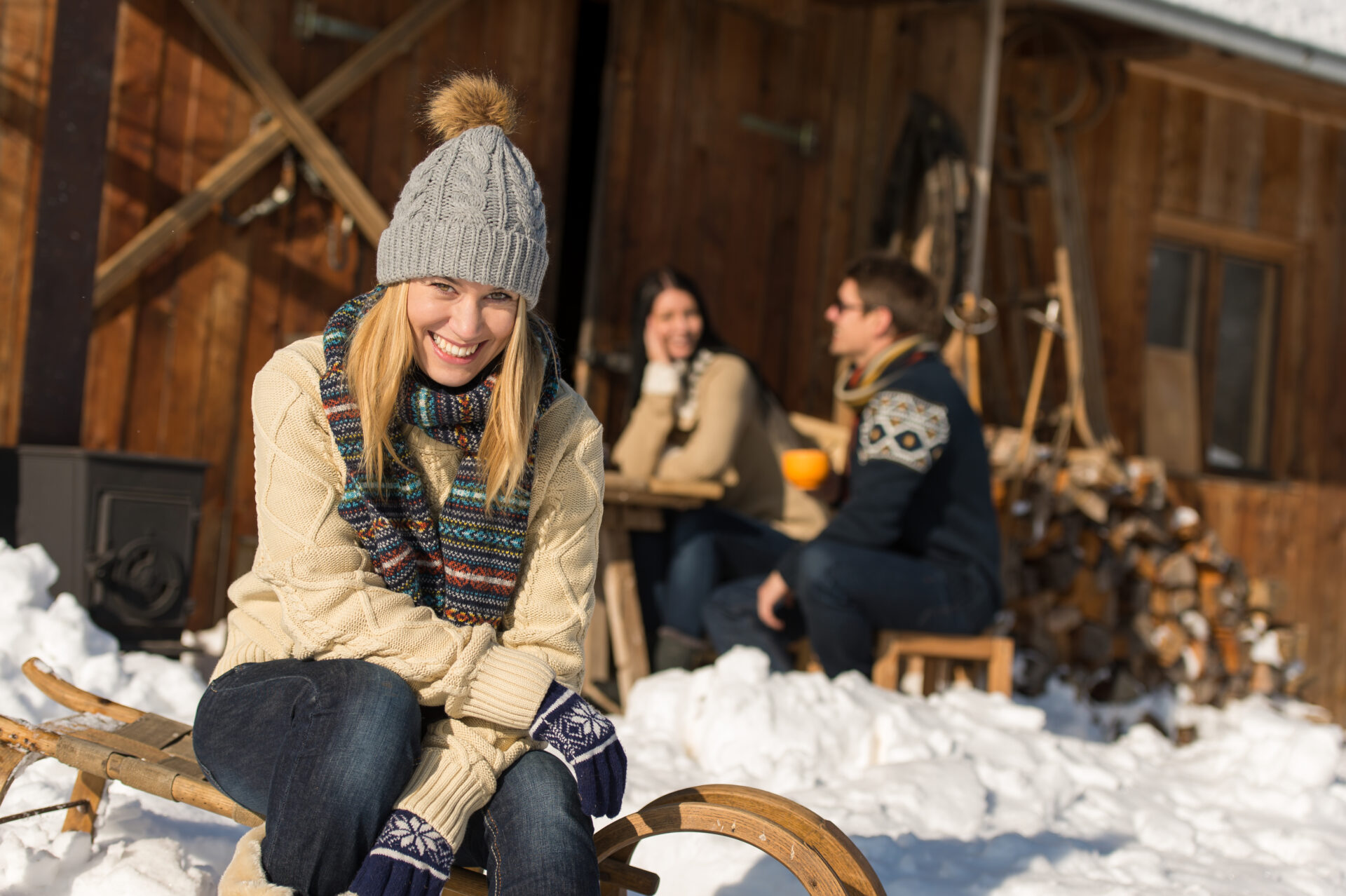 Young,Woman,With,Friends,Enjoy,Weekend,Break,Snow,Winter,Cottage