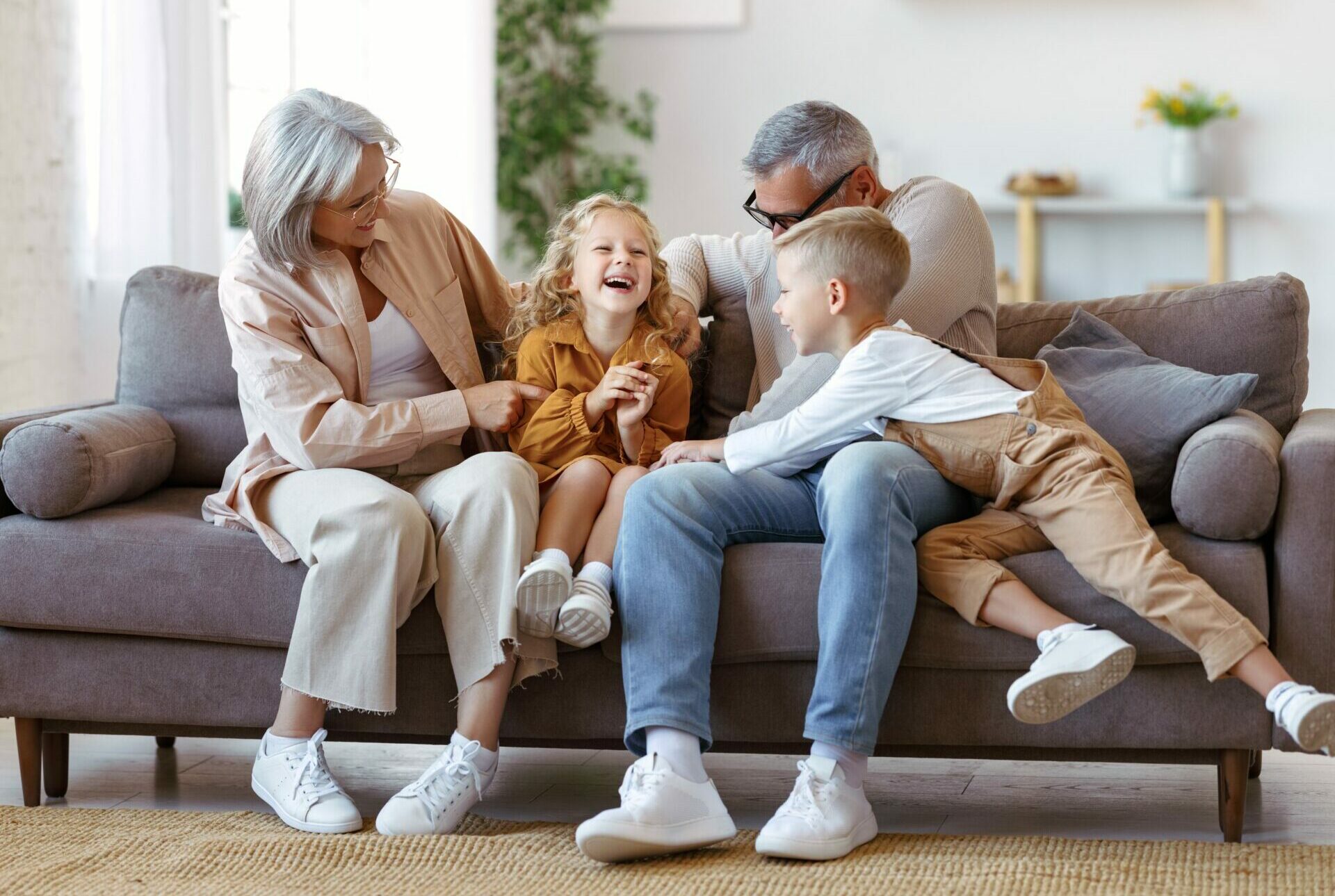 Playful,Kids,And,Grandmother,With,Grandfather,Tickling,Each,Other,While